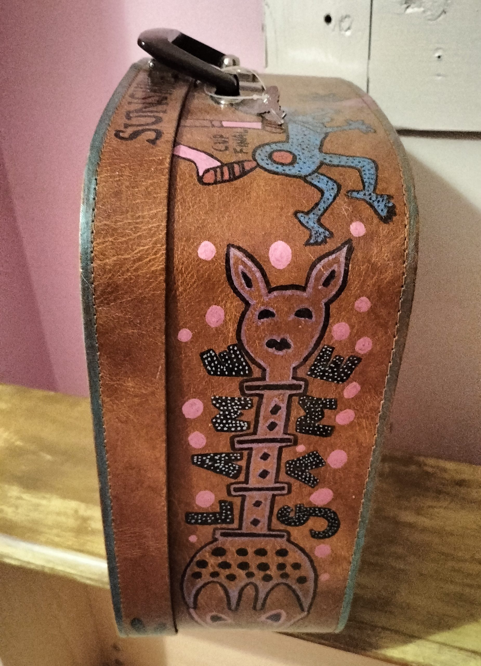 I want your baby daddy hand painted vintage vanity case. This side shows illustration of a deer like animal with a long neck and its feet are the hair of another character. Lettering around the animal says Lame Game. This is the side of the case that is hand painted on all sides.