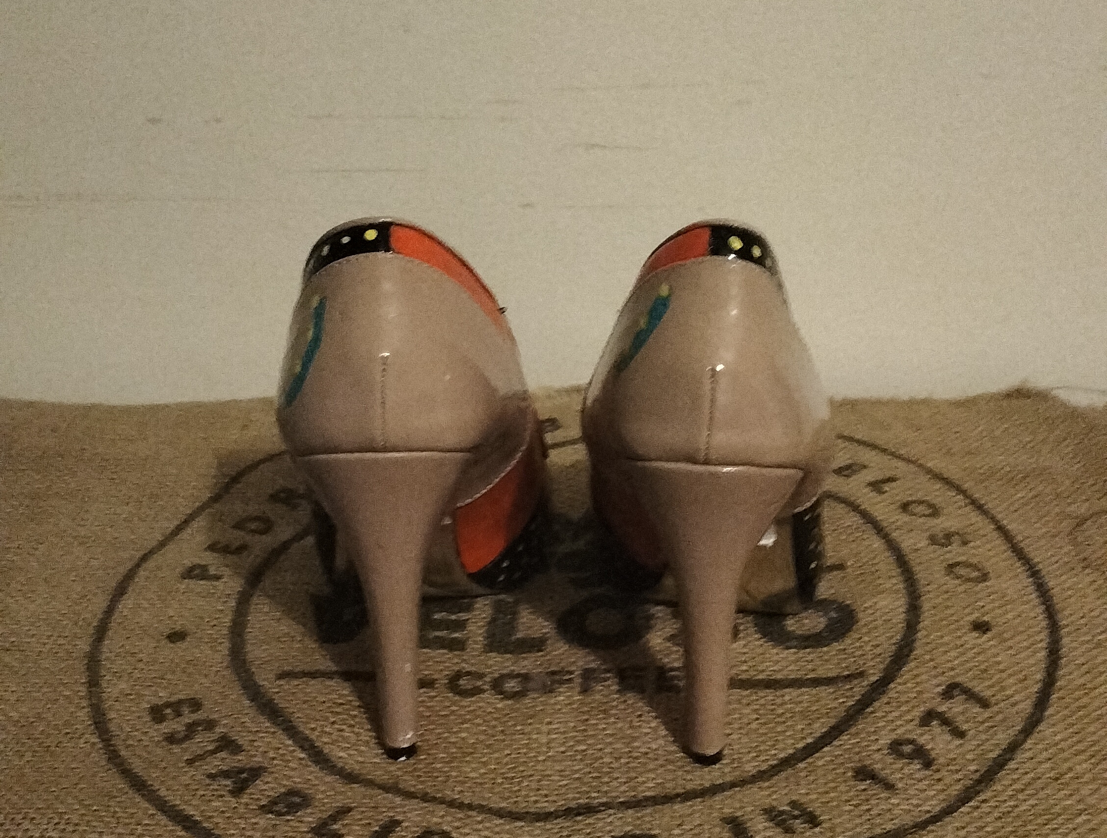 Size 6 hand painted Ben de Lisi shoes. Turquoise toes, black sections with gold spots at the front and side. Orange panels. Beige shoes, stiletto heels.