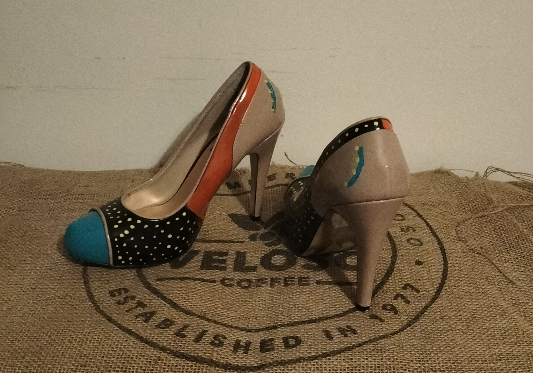 Size 6 hand painted Ben de Lisi shoes. Turquoise toes, black sections with gold spots at the front and side. Orange panels. Beige shoes, stiletto heels.