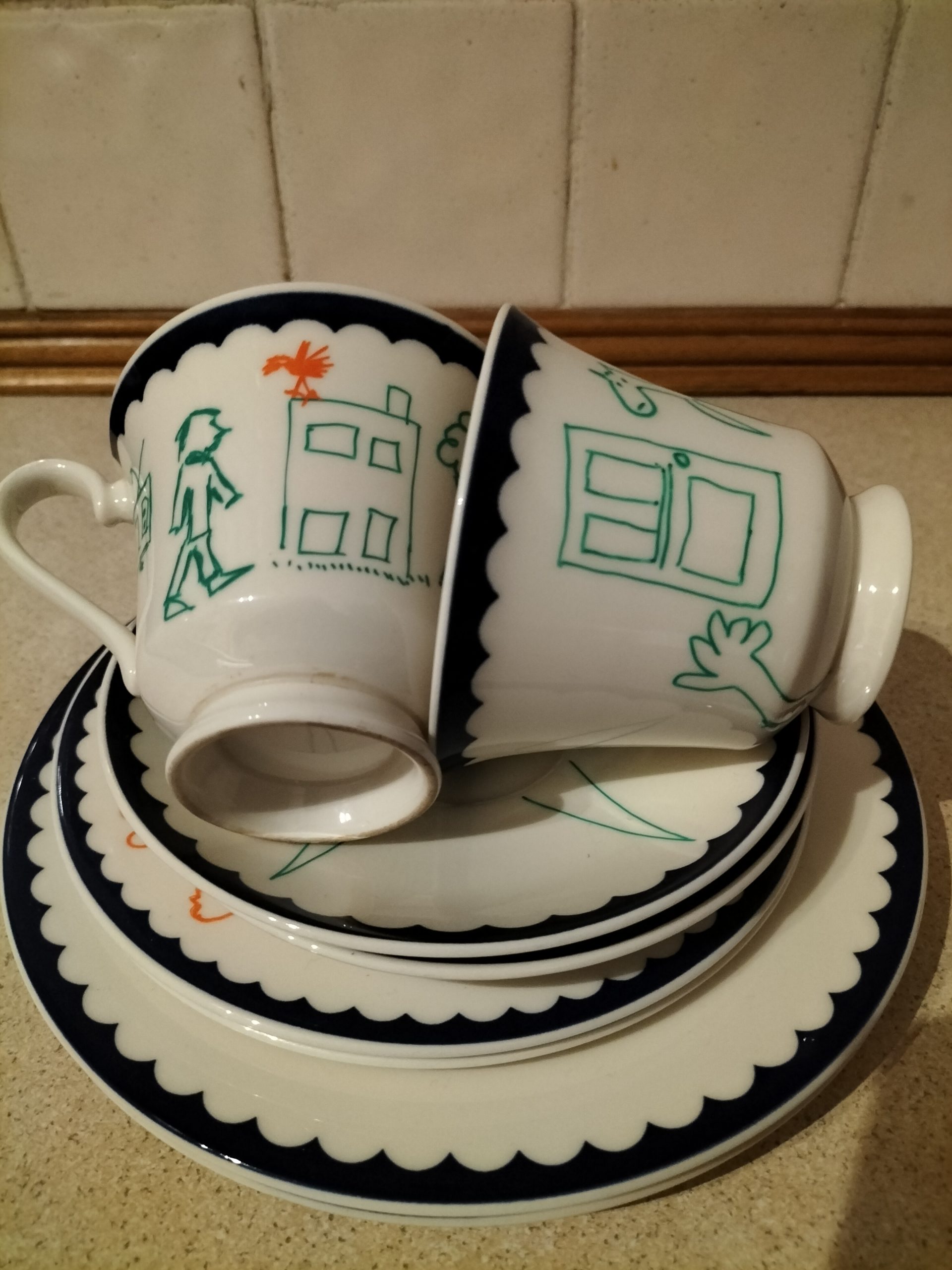 Swing Low hand painted tea set. Two cups and saucers and two small and two medium sized plates. Figures painted on the crockery. Images of people and words such as I just don't like spam. One off original art work. For display not for use.