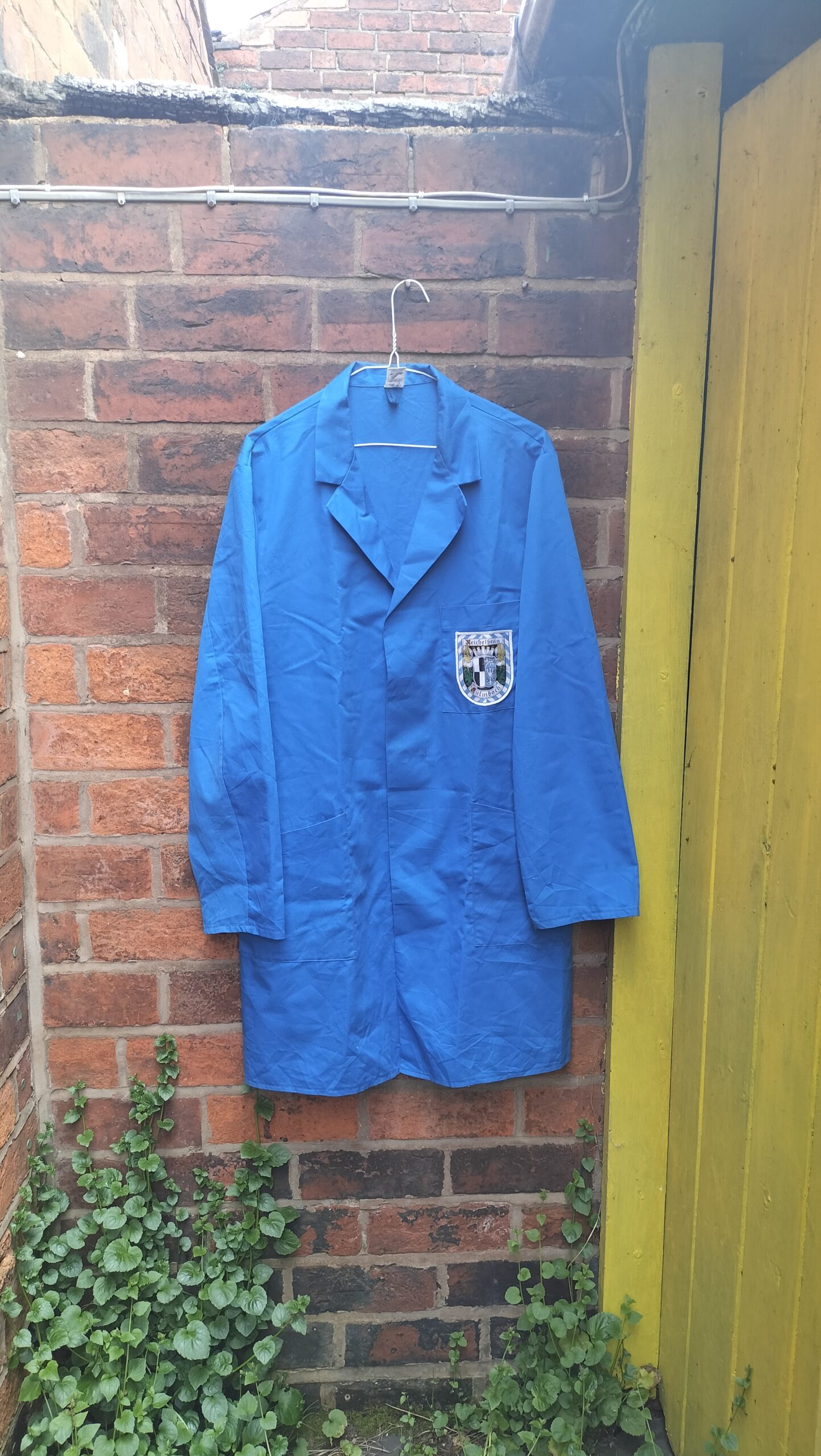 Hand painted French style worker overall. Lovely blue colour. "Shop floor worker" hand painted on the back of overalls. Front has a badge on it with Reichelbrau logo. Medium to large size. One off original.