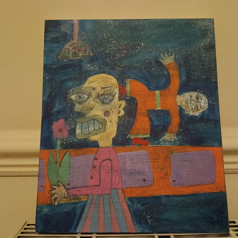 10"x12"canvas called the Orange Man. Large figure on the left holding a flower. Behind the figure is a sideboard and a smaller figure in some kind of yoga pose with one hand and one foot on the sideboard and the other foot and hand raised. There is a light at the top of the image. The smaller figure wears an orange jumpsuit. Blue background.