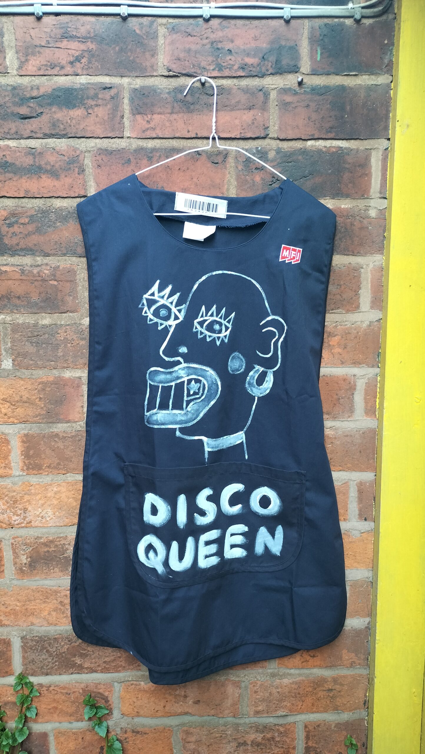 Disco Queen tabard XXL 12 to 14 label reading Dimensions. Hand painted tabard navy blue colour, cotton. On the front reads Disco Queen in white paint with an unusual face. On the back reads Ma'am in white paint.