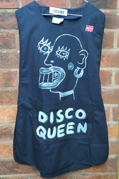 Tabard hand painted. Navy blue with face on the front in white paint. Words read "Disco Queen"