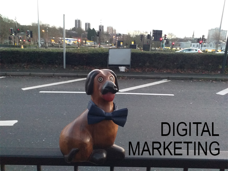 Services - digital marketing photograph of wooden dog ornament in dickie bow tie on railing at road junction