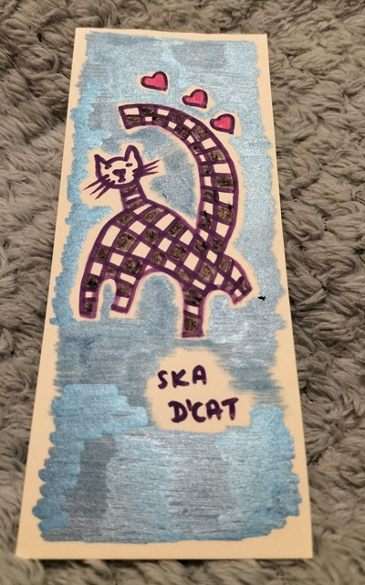 Ska d'cat little black and white cat, signature black and white squares associated with ska/two tone music. Little bookmark, blue background.