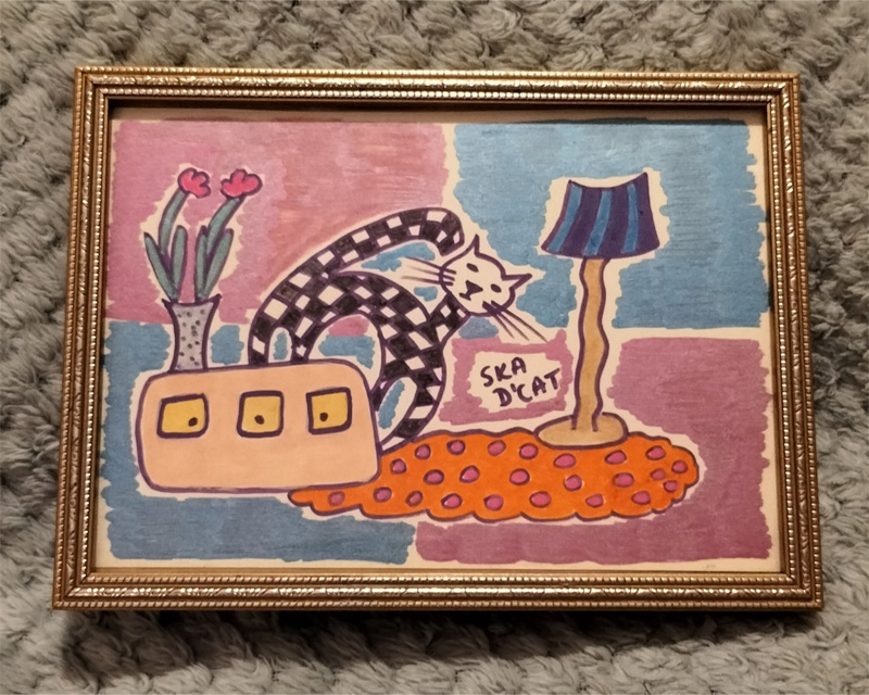 Lounge scene. Ska d'cat on sideboard that has plant on it. Rug on floor. Standing lamp. Background split into four. Pink coloured quarter top left and bottom right. Blue coloured quarter top right and bottom left. Framed.