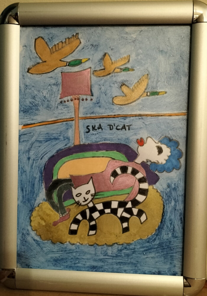 Ska d'cat original. Flying ducks on wall. Cat on rug on floor. Woman on sofa. Lounge scene.