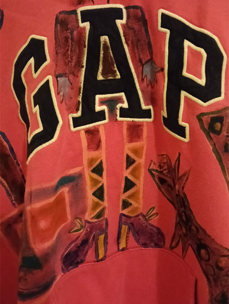 Gap hoodie size 16. Pink. Hand painted on the front. Woman figure around the A of the word Gap. Shows gap at top of legs which is referencing a woman's weight and space between her thighs. Sideboard to the left of the legs and shoes. Knee length socks. Dog to the right of the legs. Plant with leaves and flower on top of the sideboard. Vintage hoodie. Painted front and back. Back of hoodie has a star ont he hood and a figure on the back of the hoodie which is abstract, bald headed and the words Reach for the Stars appear in a box outline.Gap hoodie size 16. Pink. Hand painted on the front. Woman figure around the A of the word Gap. Shows gap at top of legs which is referencing a woman's weight and space between her thighs. Sideboard to the left of the legs and shoes. Knee length socks. Dog to the right of the legs. Plant with leaves and flower on top of the sideboard. Vintage hoodie. Painted front and back. Back of hoodie has a star ont he hood and a figure on the back of the hoodie which is abstract, bald headed and the words Reach for the Stars appear in a black line surround.