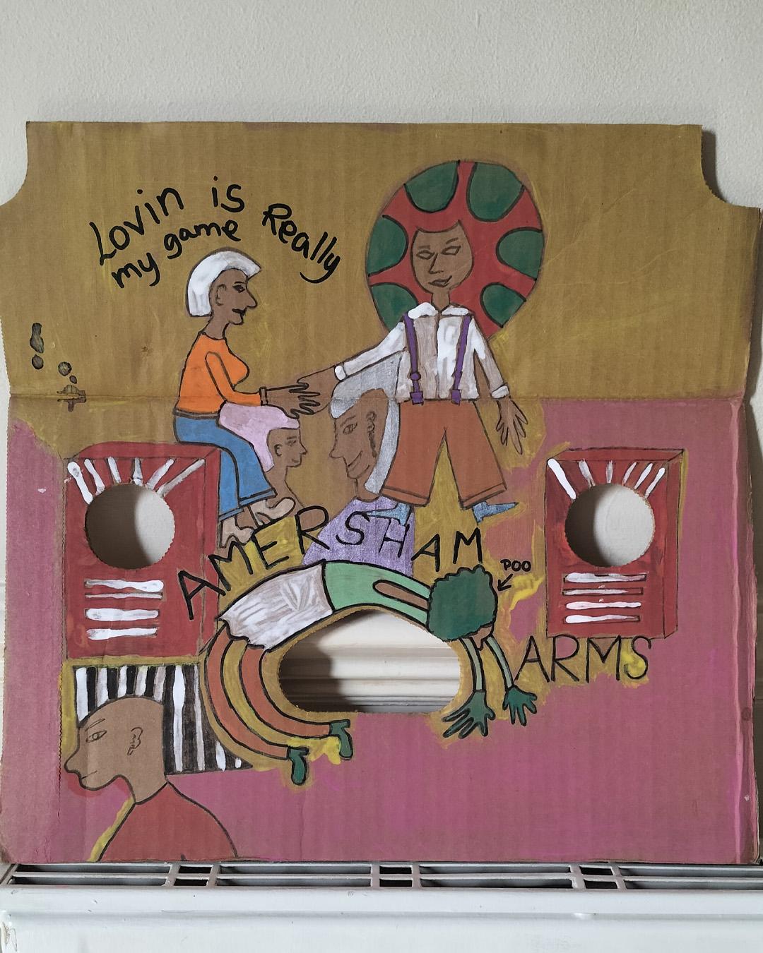 Art work on cardboard. One off. About A3 in size. Square in shape with two round holes (one on each side) and another kidney shaped hole in the middle of the card. The top left and right side of the card are like they have had a semi circle removed. Background: bottom two thirds is pink, top third is yellow (dull) Two images like music speakers around each of the round holes. Male figure to the bottom left, head and shounders. Woman backbending around the kidney shaped hole in the middle of the card. The word Amersham above the women and Arms to the right of her arms. The word Poo after Amersham so that it reads Shampoo. Woman sat on the left speaker and the words Lovin is really my game abve her. Referencing Studio 54 in New York (famous nightclub). Male figure to the right of the woman and two faces one under the woman on the left and the other under the man on the right. The art work is about a live music venue in South East London, the Amersham Arms.
