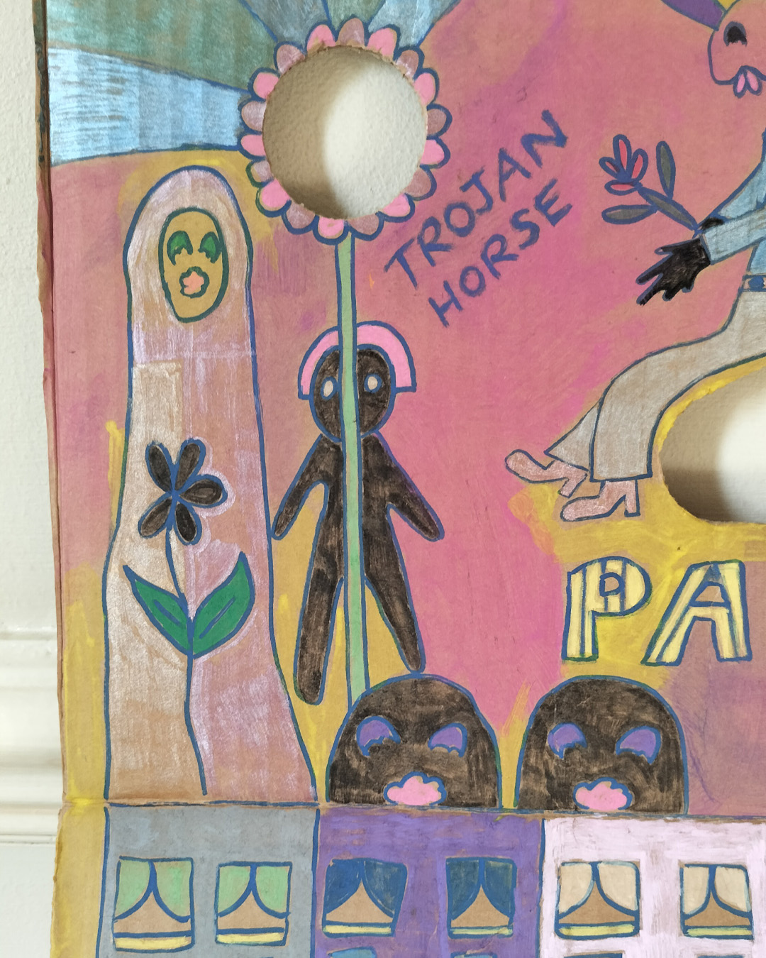 Art work on cardboard. One off. About A3 in size. Square in shape. Two round holes (one on each side) and another kidney shaped hole in the middle of the card. Background: pink and yellow in different areas. Row of houses white van and a man leaning over the van. Little path and the words White Van Man. Muslim woman on left of work. Stalk leading to hole in the cardboard and petals around the hole on both sides. Two figures sat back to back around the kidney shaped hole. The words Trojan Horse on the left of the work and Love is in the Air on the right of the work. The word Palfrey in big lettering in the middle. A bird looking up at one of the figures and a woman at the right of the image. Palfrey is an area near Walsall, West Midlands UK.