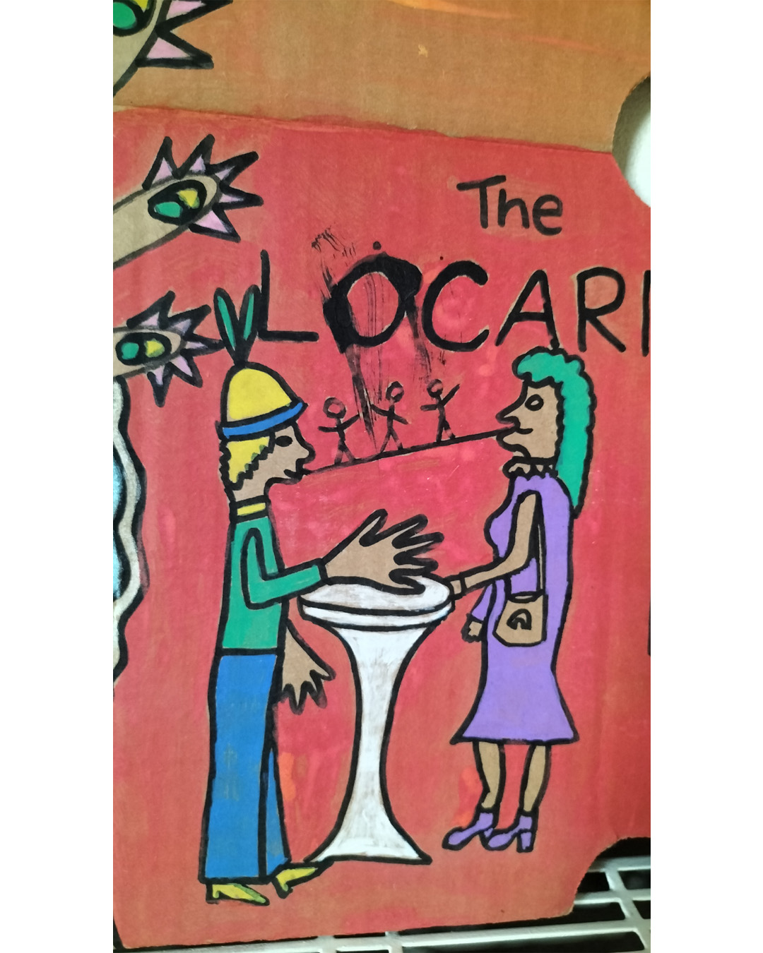 Close up of couple talking at table. The Locarno cardboard art about A3 in size. The Locarno was a nightclub in Birmingham and there were Locarno nightclubs across England. This is a scene with a woman's face in top left of cardboard where a hole is her mouth and the words Uptown Top Ranking run under her hairline and around her chin and neck. The hand of the woman is coming up from the bottom left of the cardboard and the fingers are extended and look like chickens with spikey hair and a beak around each finger and the nail looks like an eyeball with eyelid (not detailed). There is the words The Locarno on the piece and a man and woman standing talking at a tall table. There is another woman under the hand where you only see part of her face. To the right of the image is a doorway and it looks like inside a room with slabs for stairway leading there. This is only small on the right side of the cardboard. Background is pink for the bottom two thirds of the cardboard and a kind of orange for the top third of the card.
