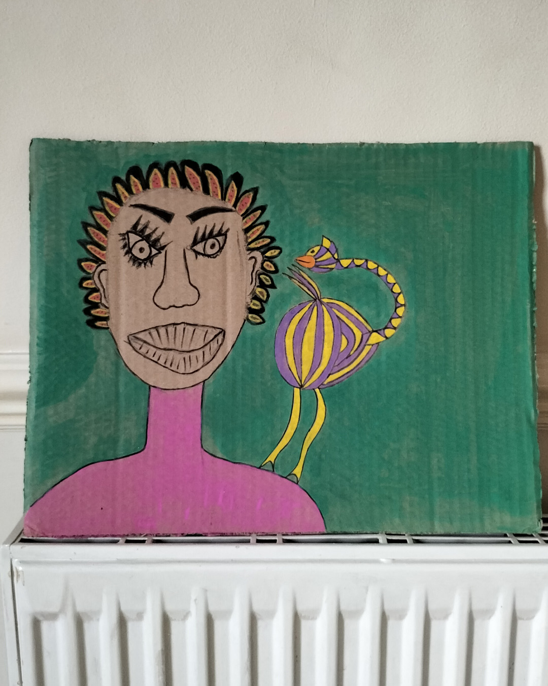 One-off art work on A3 cardboard. Green background. Black woman on the left of the image. Pink top. Hair in individual almond shapes around the head with black surround yellow and red inside with green dots. Purple and yellow bird on the woman’s shoulder. Lots of space to the right of the image.