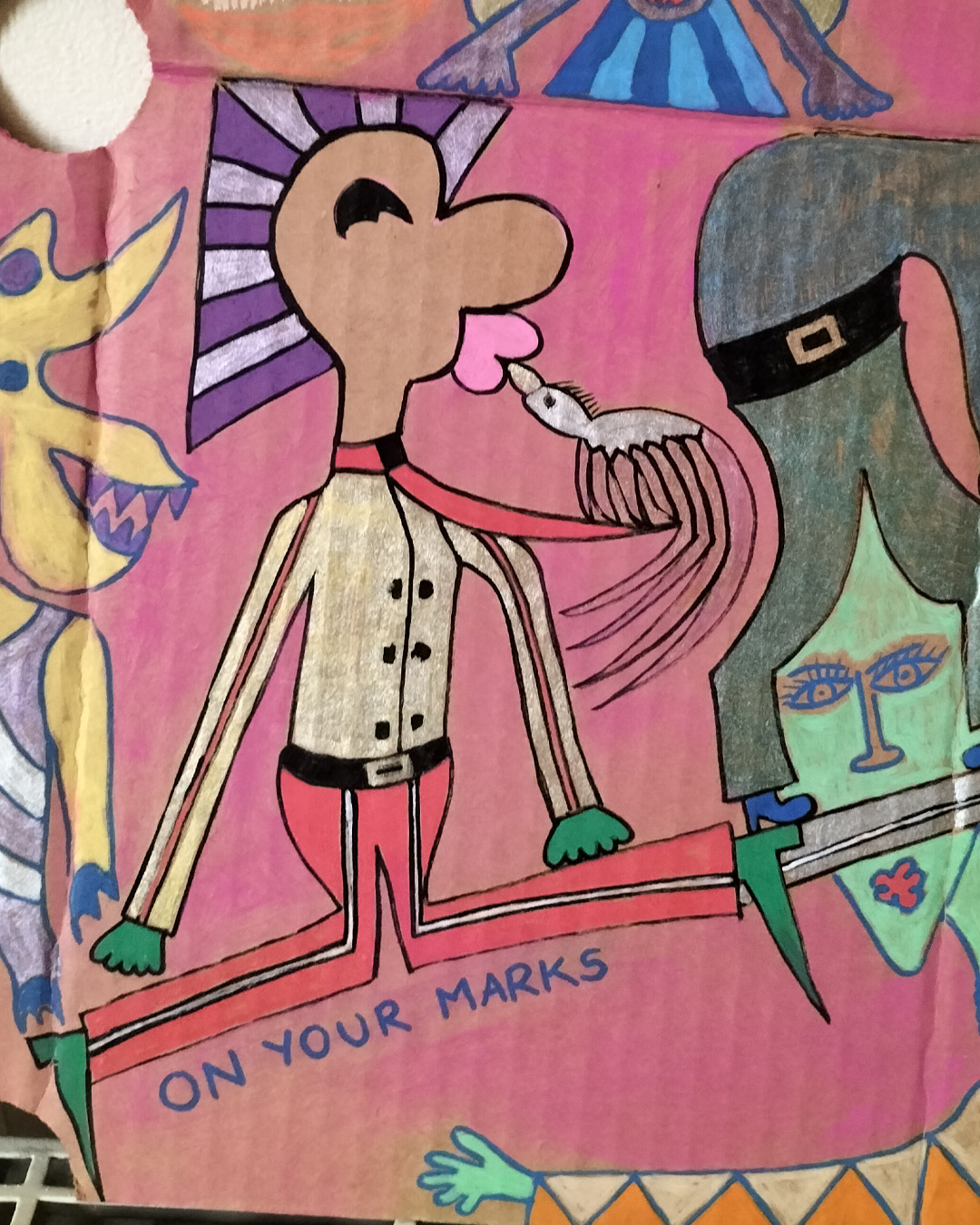 Art work on cardboard. One off. About A3 in size. Two round holes in the cardboard in the top third, one each side of the cardboard. Background: pink paint. A mix of people some merging into one. Cats legs become the hair above faces. A man on his knees is being kissed by a bird where the beak is like a whistle and the words underneath the man’s legs read On your marks. Pram Face are the words above a woman pushing a baby in a pram and the pram wheels are the eyes of a face. There is a fish above the woman pushing the pram. Fantasy figures. Two purple figures with blue two tone hair are peeping out from behind a tree trunk and there is a kind of animal next to them in some kind of full body leotard outfit perfect for sport. One figure bends over and the long blonde hair (seen from the back) is then the skirt of another figure. One off art work.